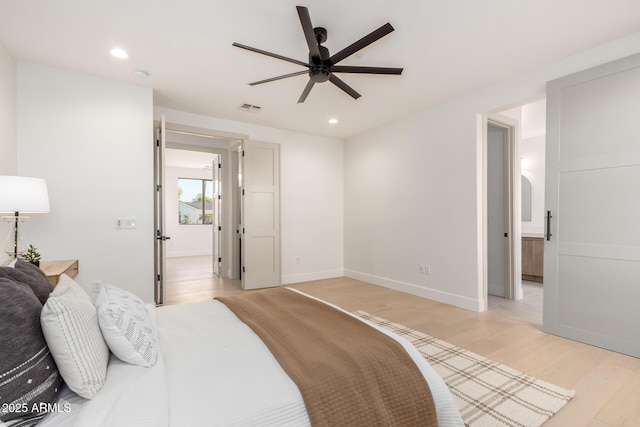 bedroom featuring recessed lighting, visible vents, light wood-style flooring, and baseboards