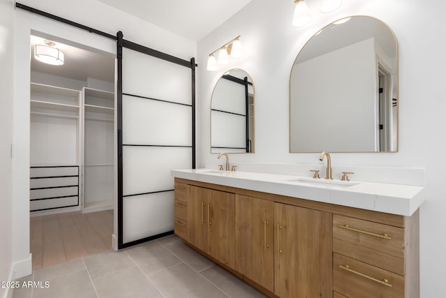 bathroom featuring double vanity, tile patterned flooring, and a sink