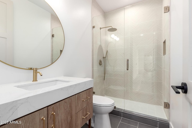 full bathroom featuring toilet, a stall shower, tile patterned flooring, and vanity