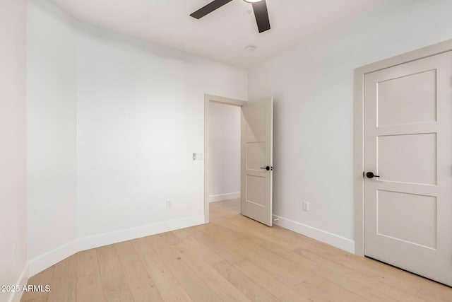 spare room with ceiling fan, baseboards, and wood finished floors