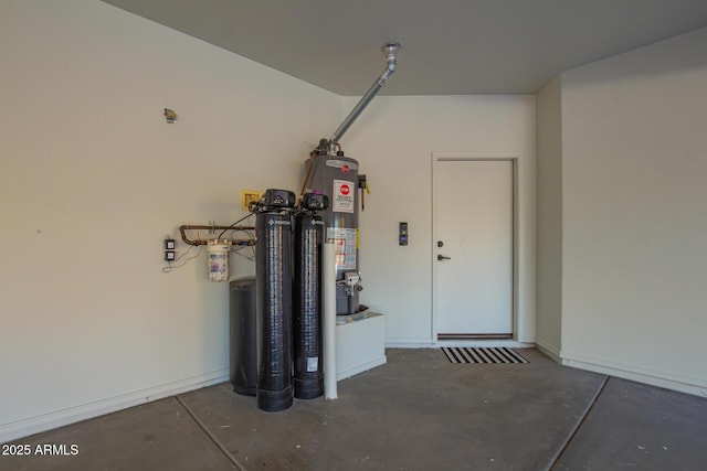 garage featuring gas water heater and baseboards