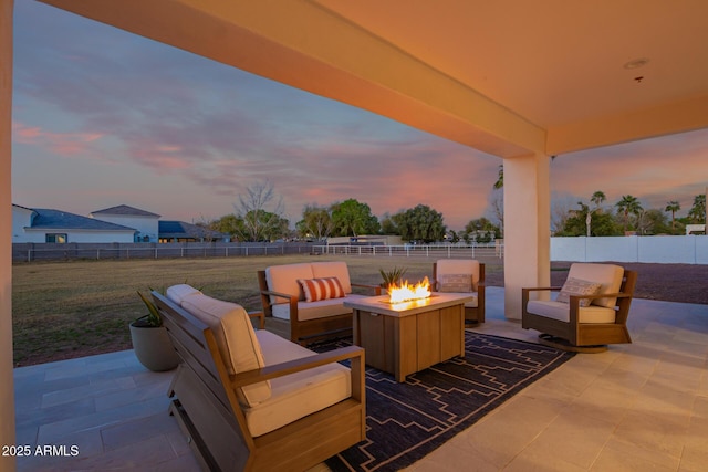 view of patio with a fenced backyard and an outdoor living space with a fire pit