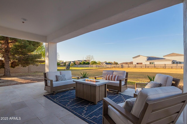 view of patio featuring an outdoor living space with a fire pit and a fenced backyard