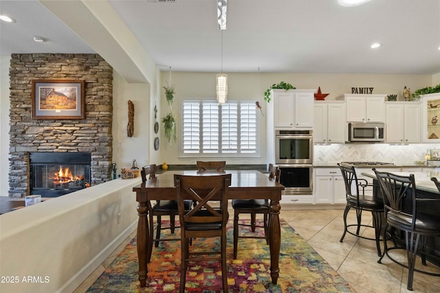 5122 S Miller Pl, Chandler, AZ 85249 - dining room featuring light tile patterned floors, recessed lighting, and a fireplace