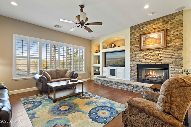 5122 S Miller Pl, Chandler, AZ 85249 - living room with built in features, a fireplace, baseboards, visible vents, and a ceiling fan