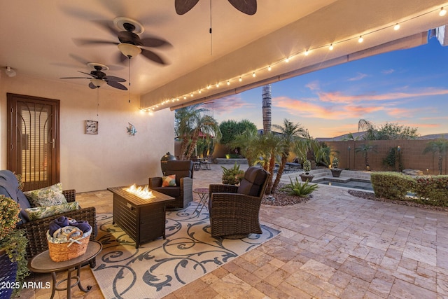 5122 S Miller Pl, Chandler, AZ 85249 - patio terrace at dusk featuring an outdoor living space with a fire pit, a ceiling fan, and fence private yard