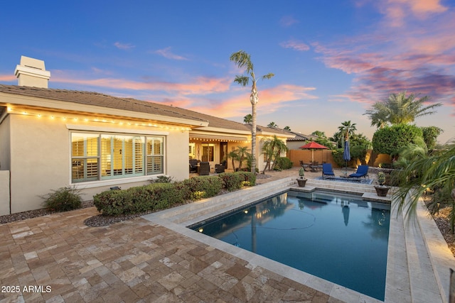5122 S Miller Pl, Chandler, AZ 85249 - pool at dusk featuring fence, an outdoor pool, and a patio area
