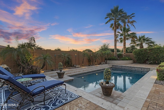 5122 S Miller Pl, Chandler, AZ 85249 - pool at dusk with a fenced backyard, a fenced in pool, and a patio area