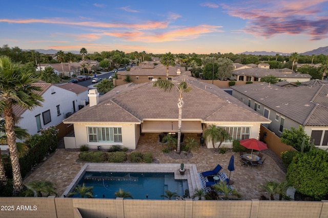 5122 S Miller Pl, Chandler, AZ 85249 - back of property at dusk featuring stucco siding, a patio area, a residential view, and a fenced backyard