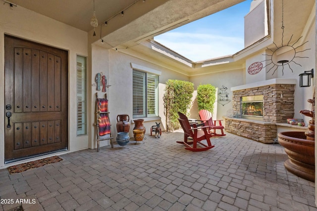 5122 S Miller Pl, Chandler, AZ 85249 - exterior space featuring a patio area, stone siding, stucco siding, and an outdoor stone fireplace