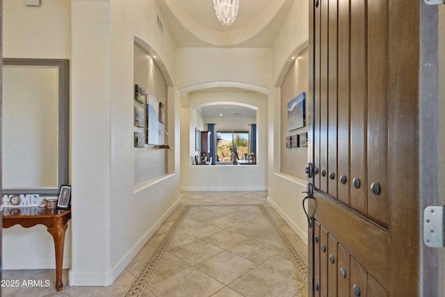 5122 S Miller Pl, Chandler, AZ 85249 - hallway with light tile patterned flooring, visible vents, baseboards, and arched walkways