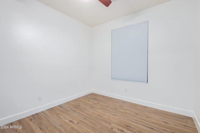 unfurnished room with hardwood / wood-style flooring and ceiling fan