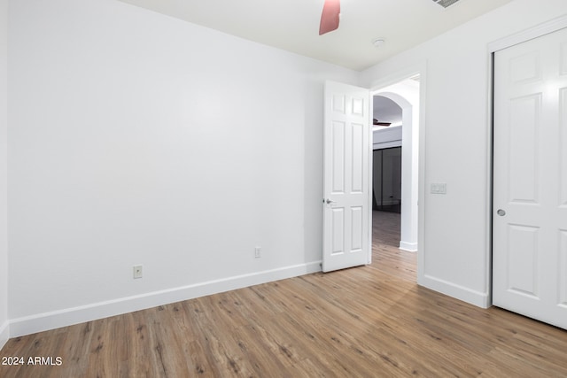 unfurnished bedroom featuring light wood-type flooring and ceiling fan