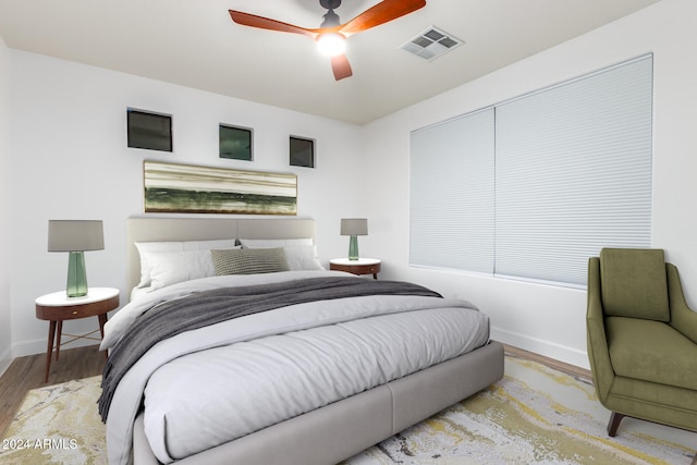 bedroom featuring light hardwood / wood-style floors and ceiling fan