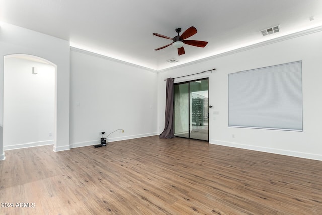 unfurnished room with wood-type flooring, ceiling fan, and crown molding