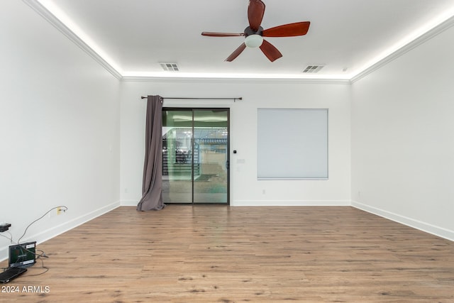 empty room featuring ceiling fan, ornamental molding, and light hardwood / wood-style flooring