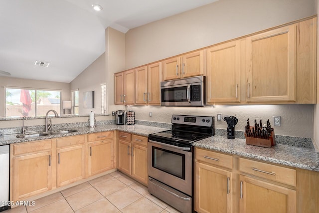 1634 E Harwell Rd, Phoenix, AZ 85042 - kitchen with appliances with stainless steel finishes, light brown cabinetry, a sink, vaulted ceiling, and light tile patterned flooring