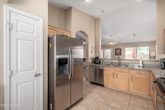 1634 E Harwell Rd, Phoenix, AZ 85042 - kitchen with stainless steel appliances, a sink, ceiling fan, light stone countertops, and light tile patterned floors