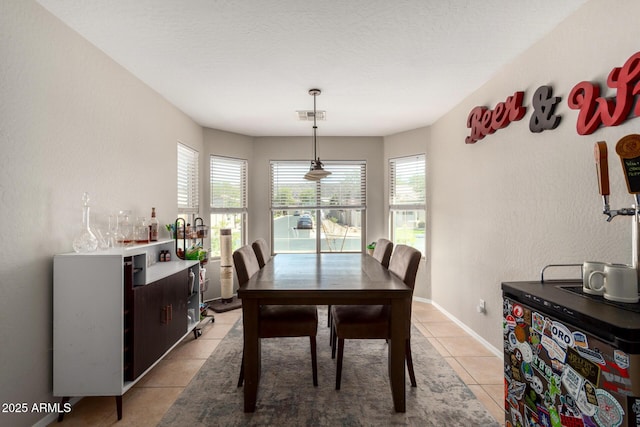 1634 E Harwell Rd, Phoenix, AZ 85042 - dining area with light tile patterned floors, healthy amount of natural light, and baseboards