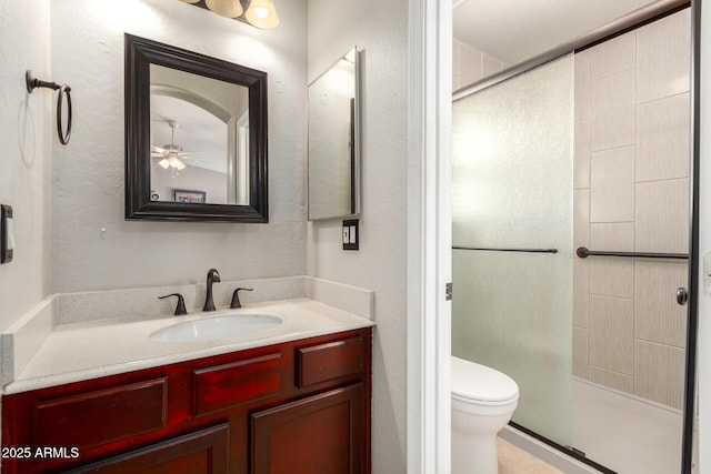 1634 E Harwell Rd, Phoenix, AZ 85042 - bathroom with a shower stall, vanity, toilet, and ceiling fan