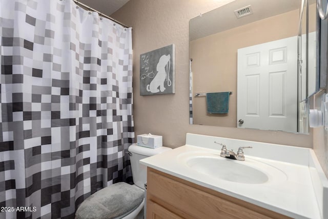 1634 E Harwell Rd, Phoenix, AZ 85042 - full bathroom with toilet, a textured wall, vanity, and a shower with shower curtain
