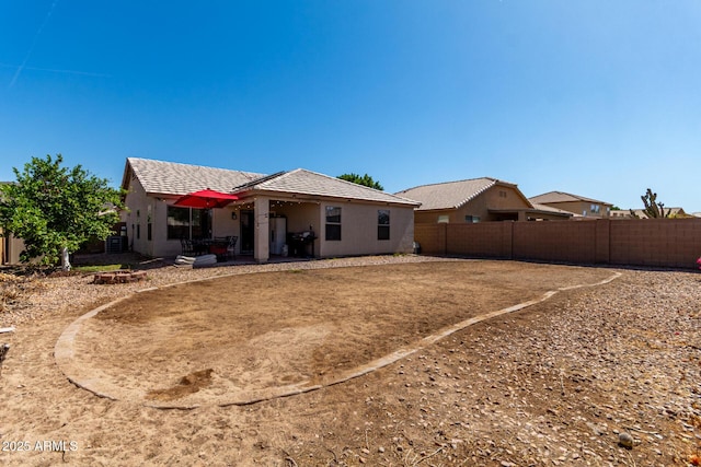 1634 E Harwell Rd, Phoenix, AZ 85042 - back of house featuring a fenced backyard, a patio, a tiled roof, and stucco siding