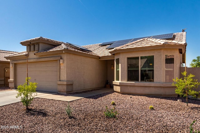 1634 E Harwell Rd, Phoenix, AZ 85042 - view of front facade featuring a tile roof, a garage, stucco siding, and solar panels