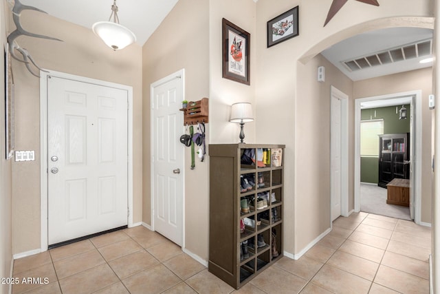 1634 E Harwell Rd, Phoenix, AZ 85042 - entrance foyer featuring arched walkways, light tile patterned floors, baseboards, and a ceiling fan