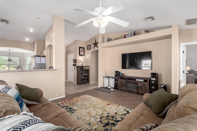 1634 E Harwell Rd, Phoenix, AZ 85042 - living room with arched walkways, a ceiling fan, baseboards, and lofted ceiling