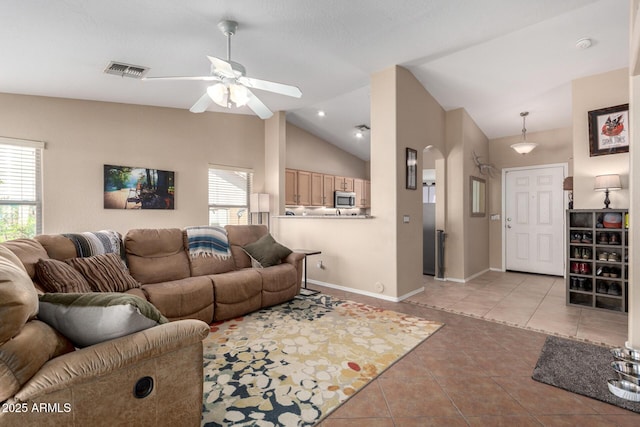 1634 E Harwell Rd, Phoenix, AZ 85042 - living room with light tile patterned floors, ceiling fan, lofted ceiling, baseboards, and arched walkways