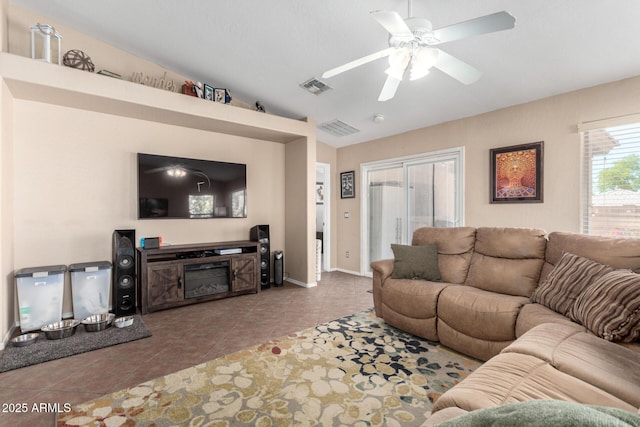 1634 E Harwell Rd, Phoenix, AZ 85042 - living area featuring ceiling fan, tile patterned flooring, vaulted ceiling, and baseboards