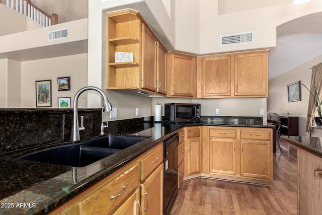 5215 W Del Rio St, Chandler, AZ 85226 - kitchen with light wood-style flooring, black dishwasher, visible vents, dark stone counters, and a sink