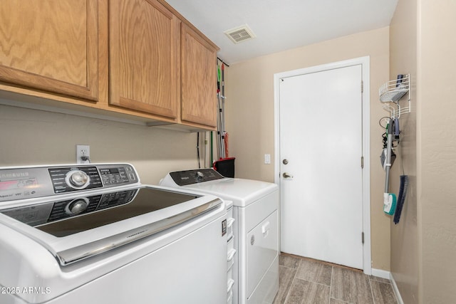 5215 W Del Rio St, Chandler, AZ 85226 - clothes washing area with wood tiled floor, visible vents, cabinet space, and washer and clothes dryer