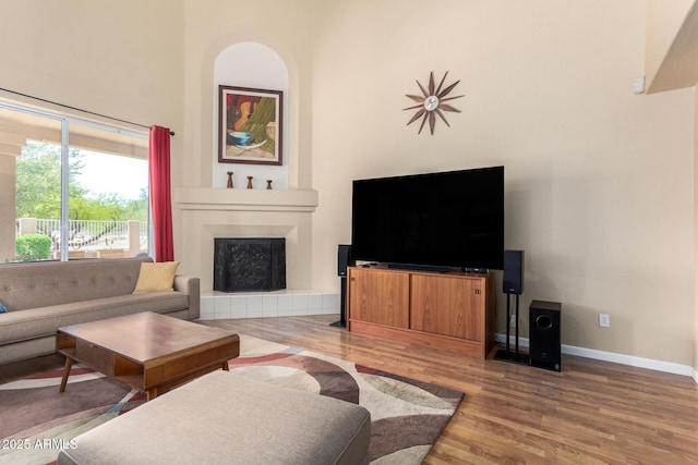 5215 W Del Rio St, Chandler, AZ 85226 - living area featuring baseboards, a towering ceiling, wood finished floors, and a fireplace