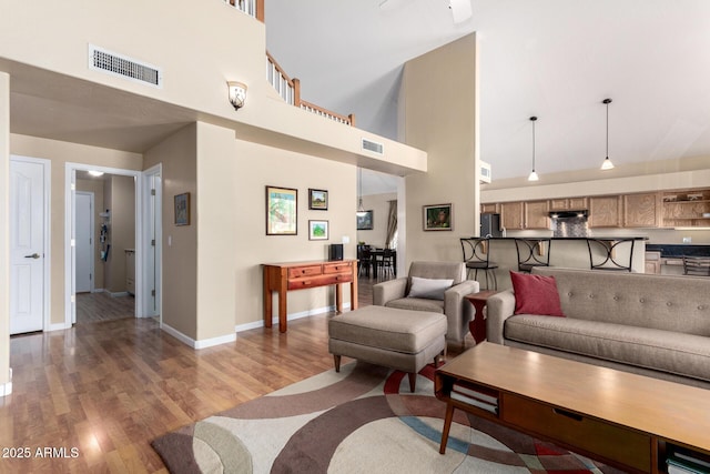 5215 W Del Rio St, Chandler, AZ 85226 - living area with baseboards, light wood-style floors, a towering ceiling, and visible vents