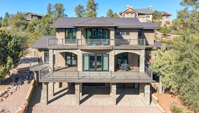 rear view of property featuring a balcony