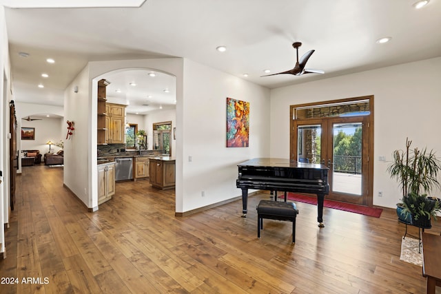 miscellaneous room with ceiling fan and light hardwood / wood-style floors