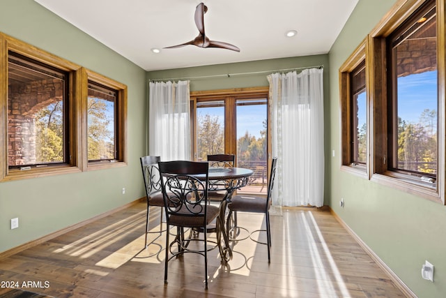 dining space with wood-type flooring