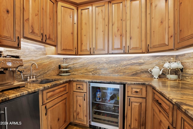 kitchen featuring beverage cooler, sink, dark stone countertops, backsplash, and stainless steel fridge