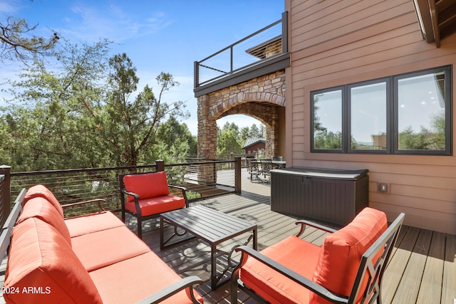 wooden terrace with an outdoor living space