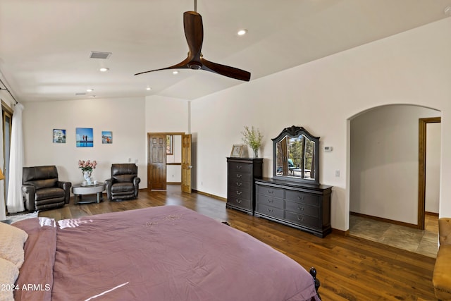 bedroom featuring ceiling fan, dark hardwood / wood-style flooring, and vaulted ceiling