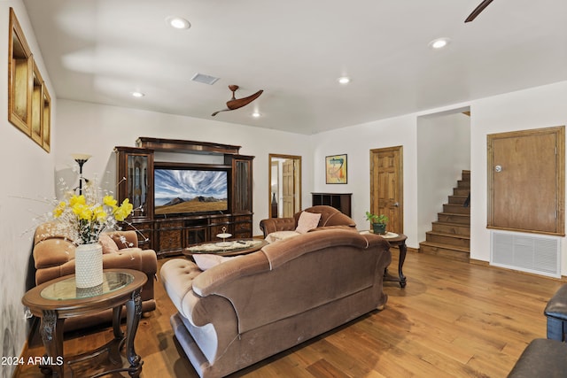 living room with ceiling fan and light wood-type flooring