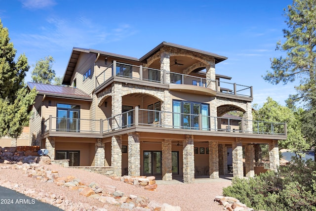 view of front of home featuring ceiling fan, a patio, and a balcony