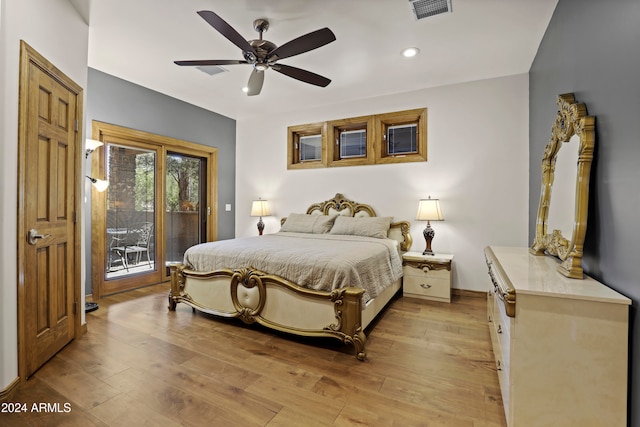 bedroom featuring access to outside, light hardwood / wood-style flooring, and ceiling fan