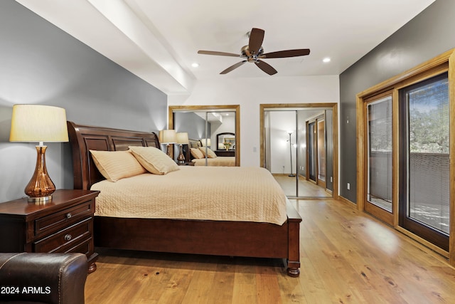 bedroom with access to exterior, two closets, ceiling fan, and light hardwood / wood-style floors