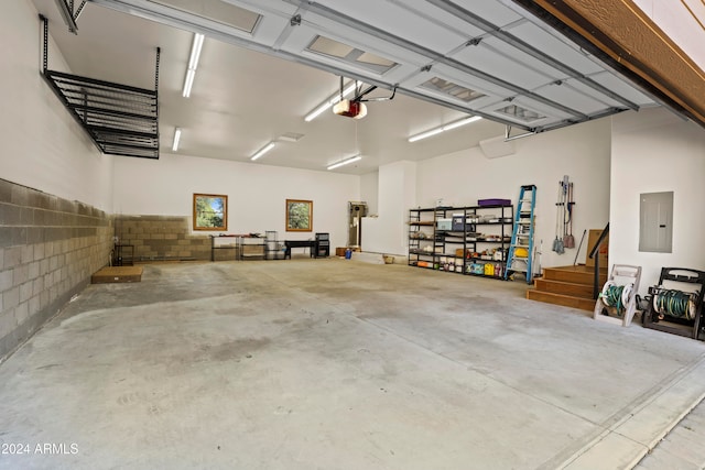 garage with electric panel and a garage door opener