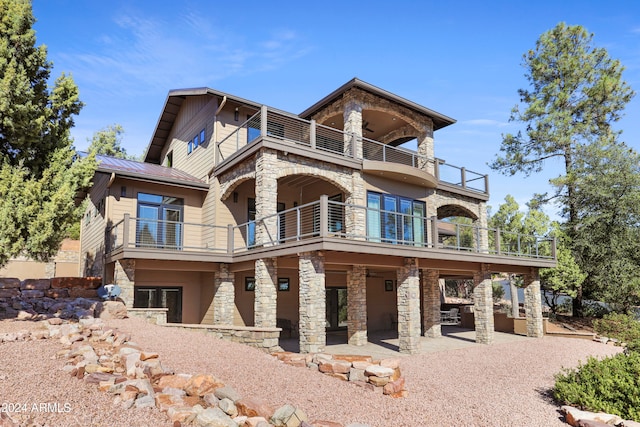 view of front of house with a balcony and a patio