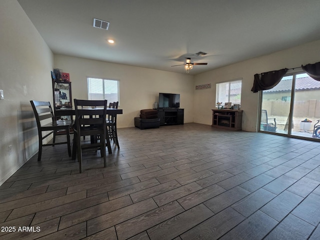 dining room with dark wood-type flooring and ceiling fan