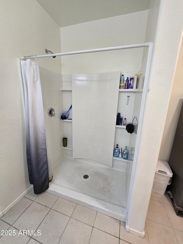 bathroom featuring curtained shower and tile patterned floors