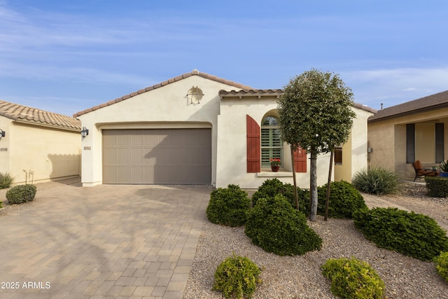 mediterranean / spanish home with a garage